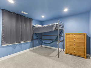 Carpeted bedroom with recessed lighting and baseboards