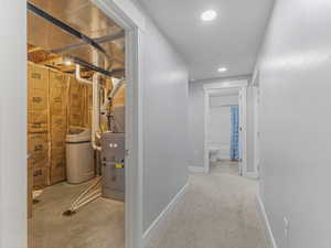 Hall featuring recessed lighting and baseboards