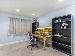 Carpeted office space with recessed lighting, visible vents, and baseboards
