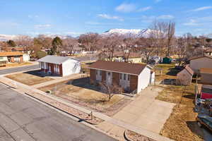 Single story home featuring a residential view, a mountain view, and fence