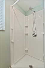 Bathroom with tiled shower and a textured ceiling