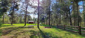 View of yard with fence and an outbuilding