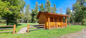 View of outdoor structure featuring an outdoor structure and fence