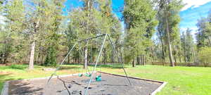 View of yard featuring playground community and fence