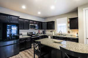 Kitchen with granite countertops, fridge stays