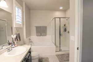 Primary bathroom with walk-in closet and separate tub and shower