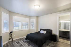 Primary bedroom with ensuite bathroom and walk in closet.  LVP flooring and plantation shutters.