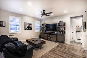 Living room with LVP flooring, plantation shutters