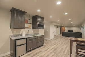 Basement Livingroom with Wet Bar, Plantation Shutters, and LVP Flooring