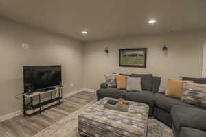 Basement Livingroom with Wet Bar, Plantation Shutters, and LVP Flooring