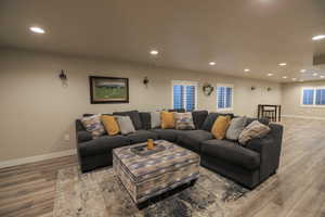 Basement Livingroom with Wet Bar, Plantation Shutters, and LVP Flooring