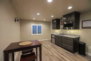 Basement Livingroom with Wet Bar, Plantation Shutters, and LVP Flooring