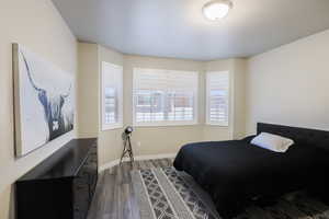 Primary bedroom with ensuite bathroom and walk in closet.  LVP flooring and plantation shutters.