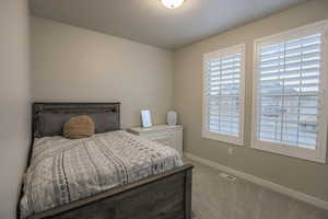 Upstairs bedroom with carpet and plantation shutters