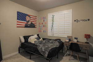 Upstairs bedroom with carpet and plantation shutters