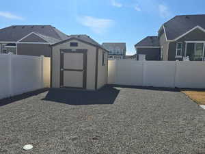 View of shed featuring a fenced backyard