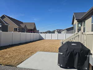 View of yard with a patio area, a fenced backyard, and a residential view