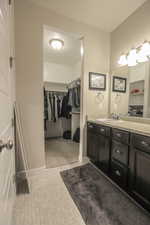 Primary bathroom with walk-in closet and separate tub and shower