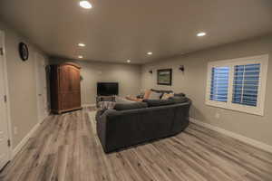 Basement Livingroom with Wet Bar, Plantation Shutters, and LVP Flooring