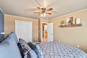 Bedroom featuring carpet, a closet, a ceiling fan, a textured ceiling, and baseboards