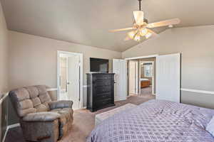 Bedroom featuring carpet, ceiling fan, lofted ceiling, and baseboards