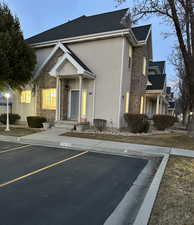View of property featuring uncovered parking