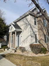 View of front of home with brick siding and a front yard