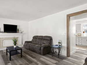 Living room featuring light wood-type flooring and baseboards