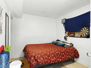 Bedroom with baseboards and tile patterned floors