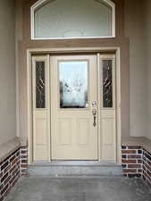 Entrance to property with stucco siding