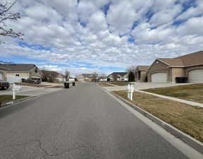 View of road featuring sidewalks, a residential view, and curbs