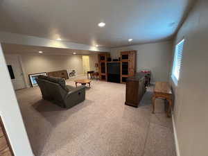 Living room featuring recessed lighting, visible vents, baseboards, and light colored carpet