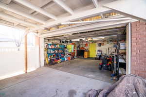 View of 2 car garage with door to art room/workshop