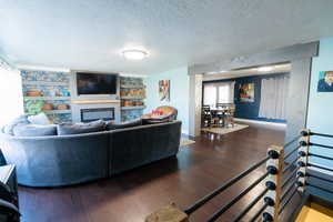 Living area with a glass covered fireplace and bamboo flooring