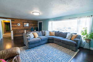 Living room featuring hardwood / wood-style flooring and a textured ceiling