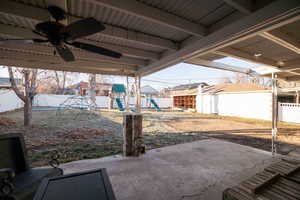 View of yard with a patio area, a playground, and a fenced backyard