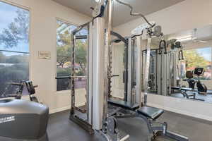 Club House. Workout area with ceiling fan and baseboards