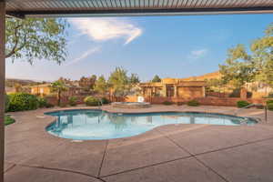 Club House. View of swimming pool with a patio, fence, a fenced in pool, and an in ground hot tub