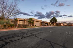 Pueblo-style house with an attached garage and stucco siding