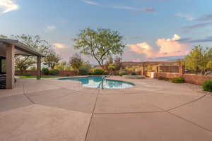 Club House. View of pool with a fenced in pool, a patio area, a fenced backyard, and an in ground hot tub