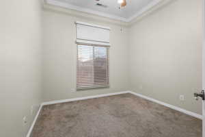 Spare room featuring a ceiling fan, carpet, visible vents, and baseboards