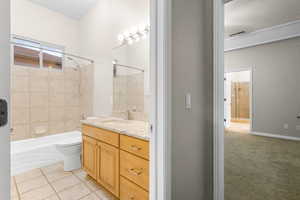 Full bath with visible vents, toilet, tile patterned floors, tub / shower combination, and vanity