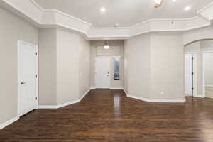 Entryway with arched walkways, recessed lighting, ceiling fan, wood finished floors, and baseboards