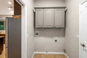 Washroom featuring hookup for a washing machine, hookup for a gas dryer, visible vents, electric dryer hookup, and laundry area