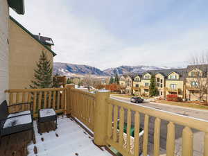 Wooden terrace with a residential view and a mountain view