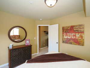 Carpeted bedroom featuring baseboards