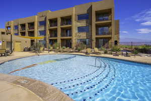 View of swimming pool with fence and a patio