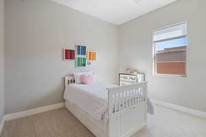 Carpeted bedroom with baseboards