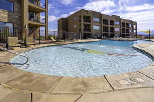 Pool featuring fence and a patio