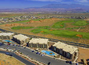 Aerial view featuring golf course view and community pools